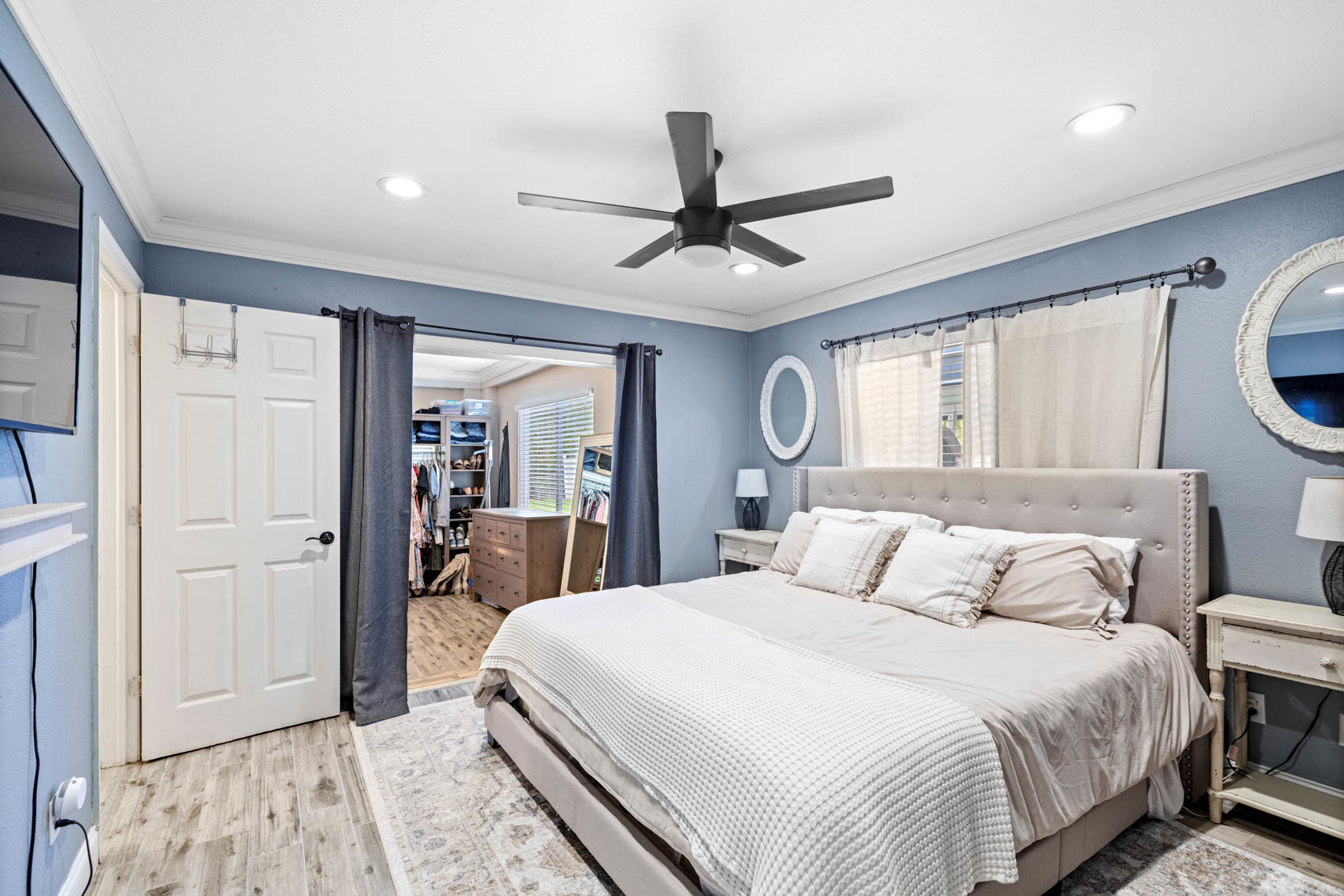 primary bedroom with white bed and blue walls